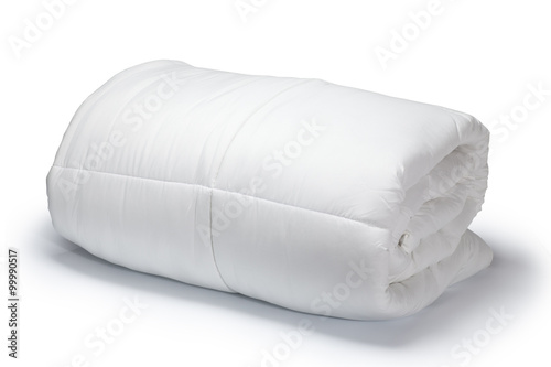 Warm and confortable folded white quilt on white background photo