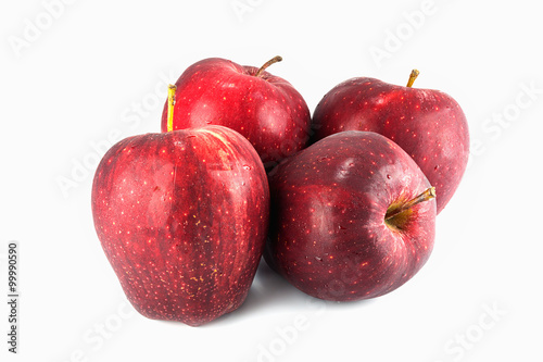 Four fresh red apples with drops isolated on white
