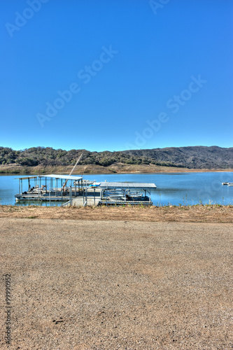 Lake Casitas boats with low water line in background. © motionshooter