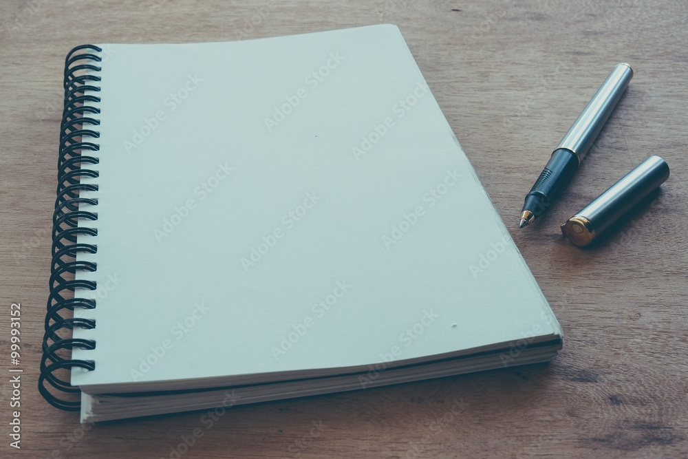 paper notebook and pen on a table with filter effect retro vinta paper notebook and pen on a table with filter effect retro vinta
