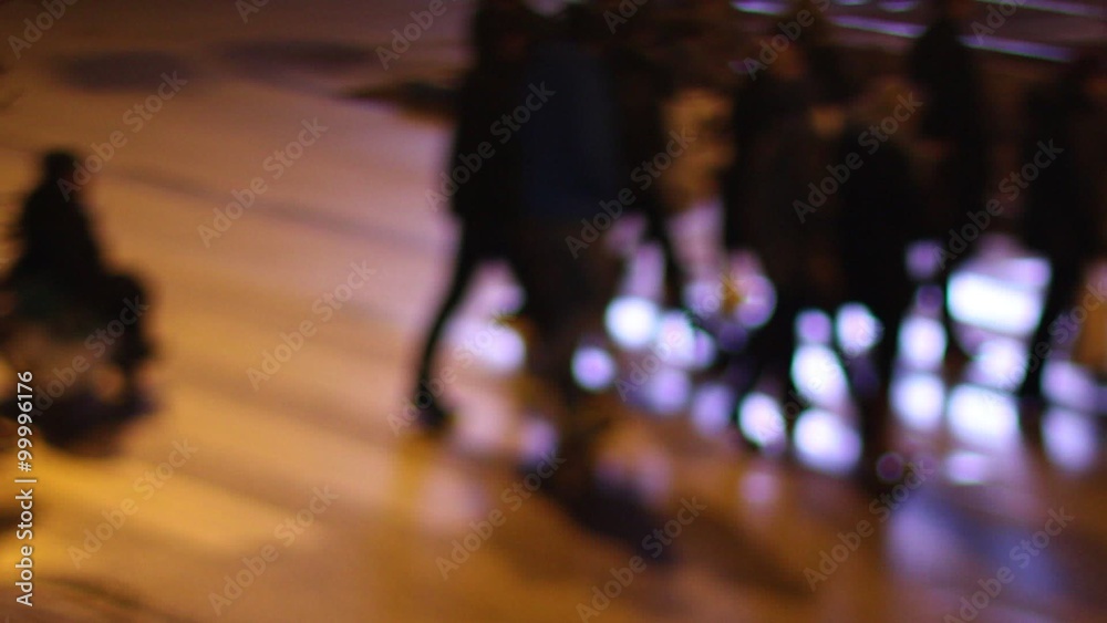 Pedestrians at night in a city