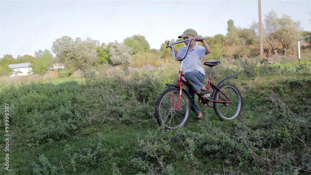 learn to ride a bike/child learns to ride a big bike on the grass learn to ride a bike/child learns to ride a big bike on the grass
