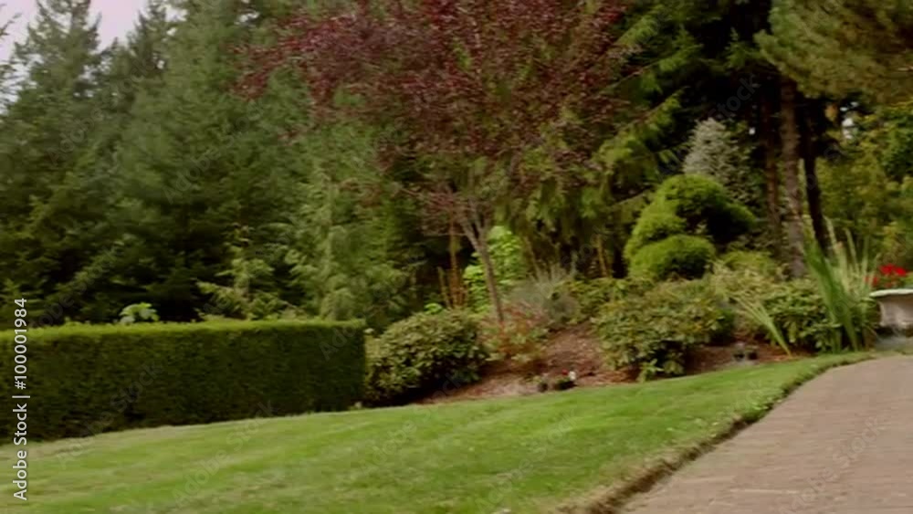 Tour through a property with beautiful landscaping, a pool and a view, in slow motion Tour through a property with beautiful landscaping, a pool and a view, in slow motion