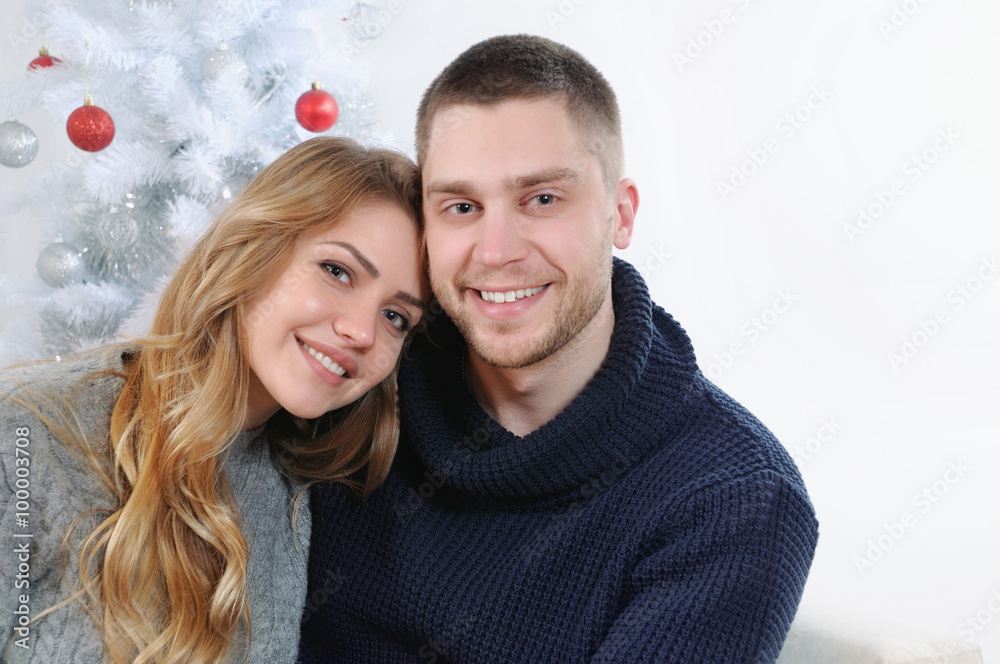 happy smiling couple at the Christmas tree happy smiling couple at the Christmas tree