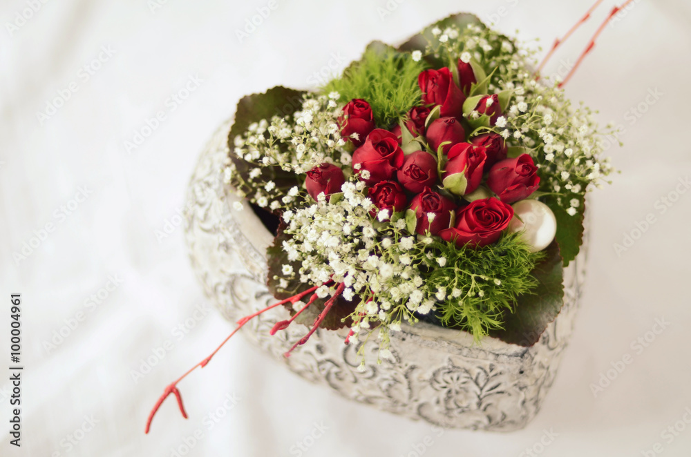 Flowers deco in a heart-shaped pot on white background Flowers deco in a heart-shaped pot on white background
