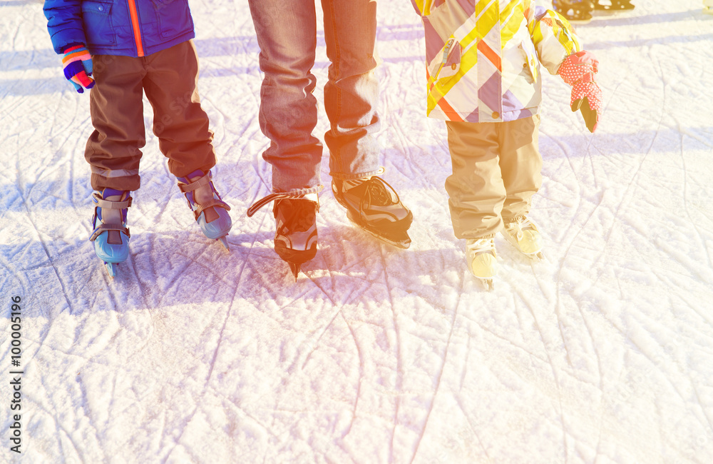 Φωτογραφία father with kids skating in winter, family winter sport