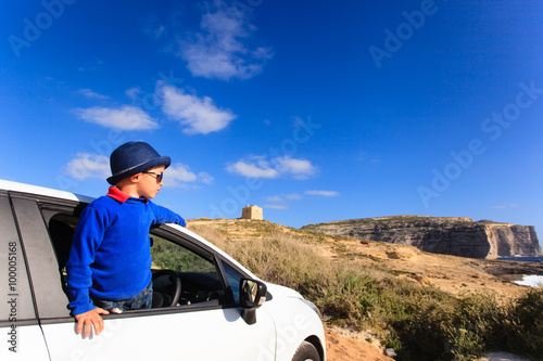 happy little boy travel by car on summer vacation