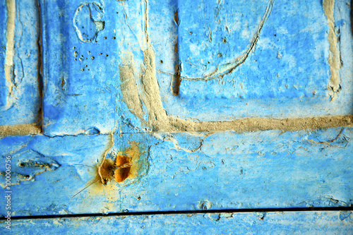 dirty stripped   in  blue wood   rusty nail photo