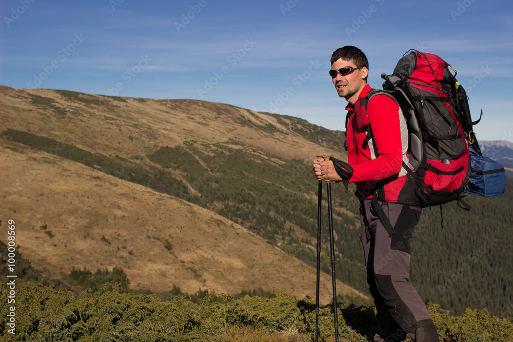 
    Hiker hiking in the mountains on a sunny day.