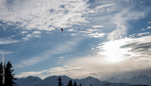 Sunset vith paraglide over winter Alps