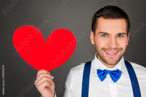 Close up photo pf handsome man with red paper heart