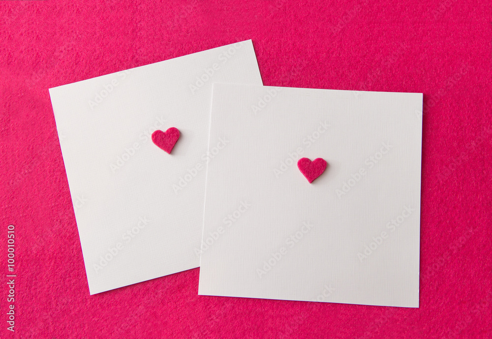 two card on pink background with pink felt hearts and place for
