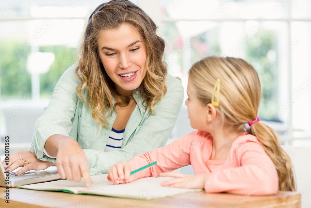 Mother checking daughter's homework