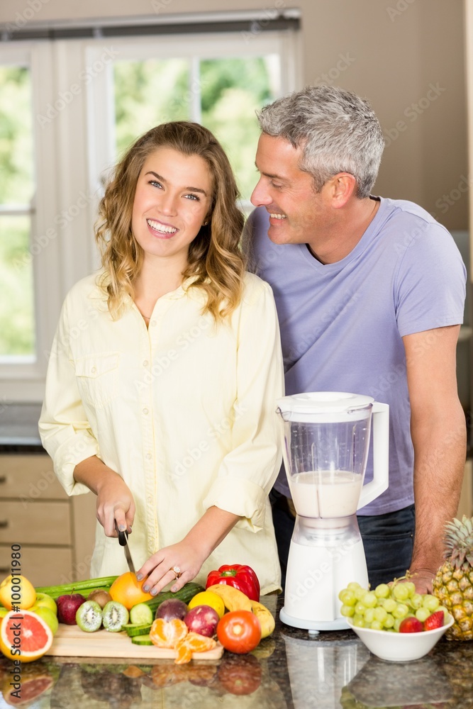 Smiling couple preparing healthy smoothie Smiling couple preparing healthy smoothie