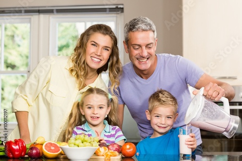 Happy family preparing healthy smoothie