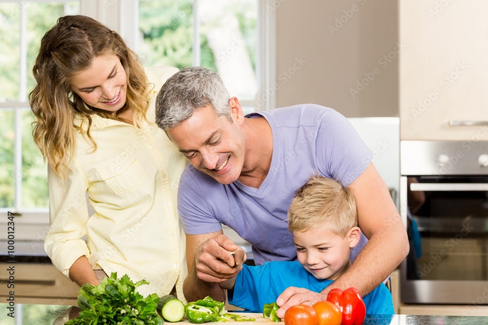 Happy family slicing vegetables Happy family slicing vegetables