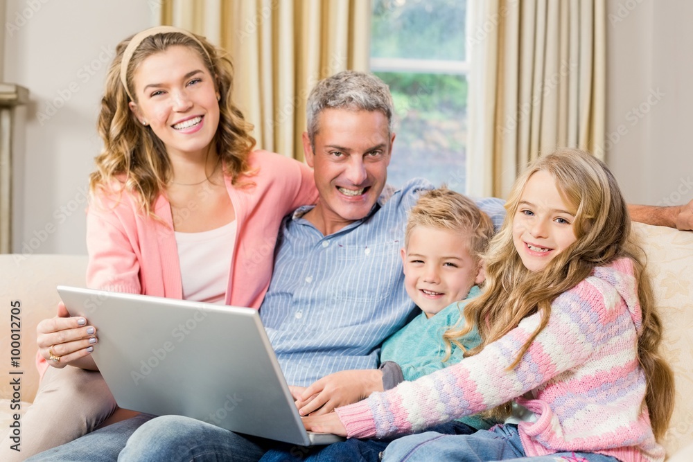 Happy family using laptop on the sofa Happy family using laptop on the sofa