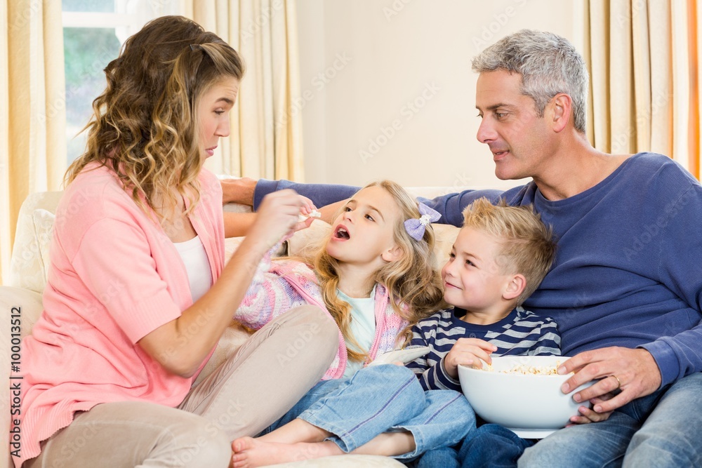 Happy family enjoying a movie together at home