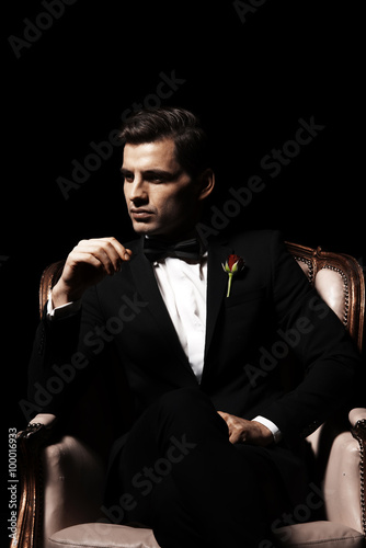 Portrait of man who sitting on chair, godfather-like character. © Aarrttuurr