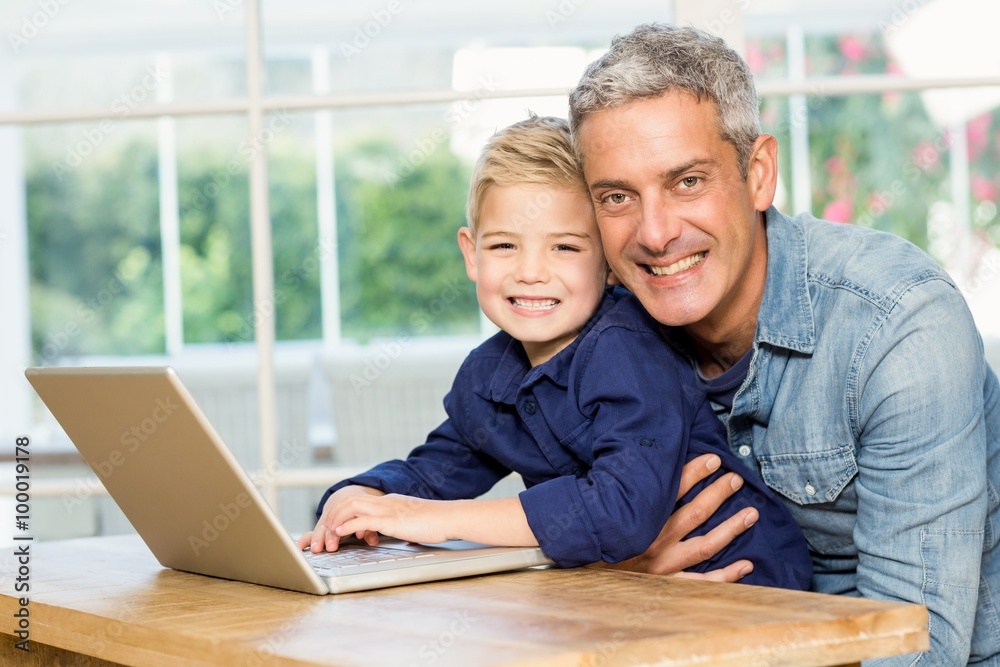 Father and son using laptop Father and son using laptop