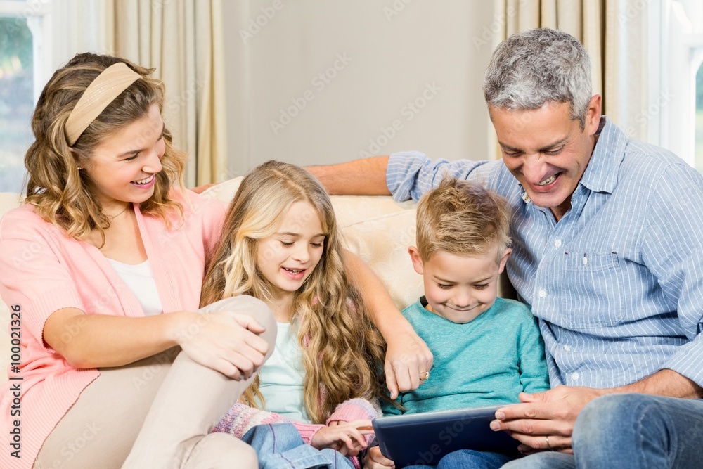 Happy family using tablet on the sofa Happy family using tablet on the sofa
