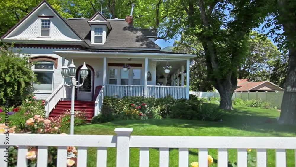 Panning shot of the front of cute little house.