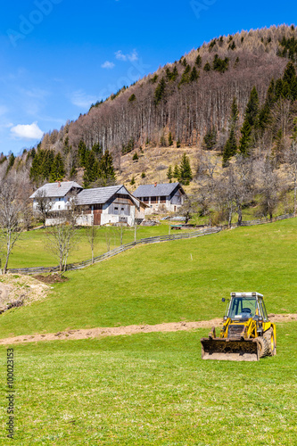 Rural Landscape With Field,Forest,Barn And Tractor