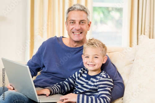 Father and son using laptop on the sofa © WavebreakmediaMicro