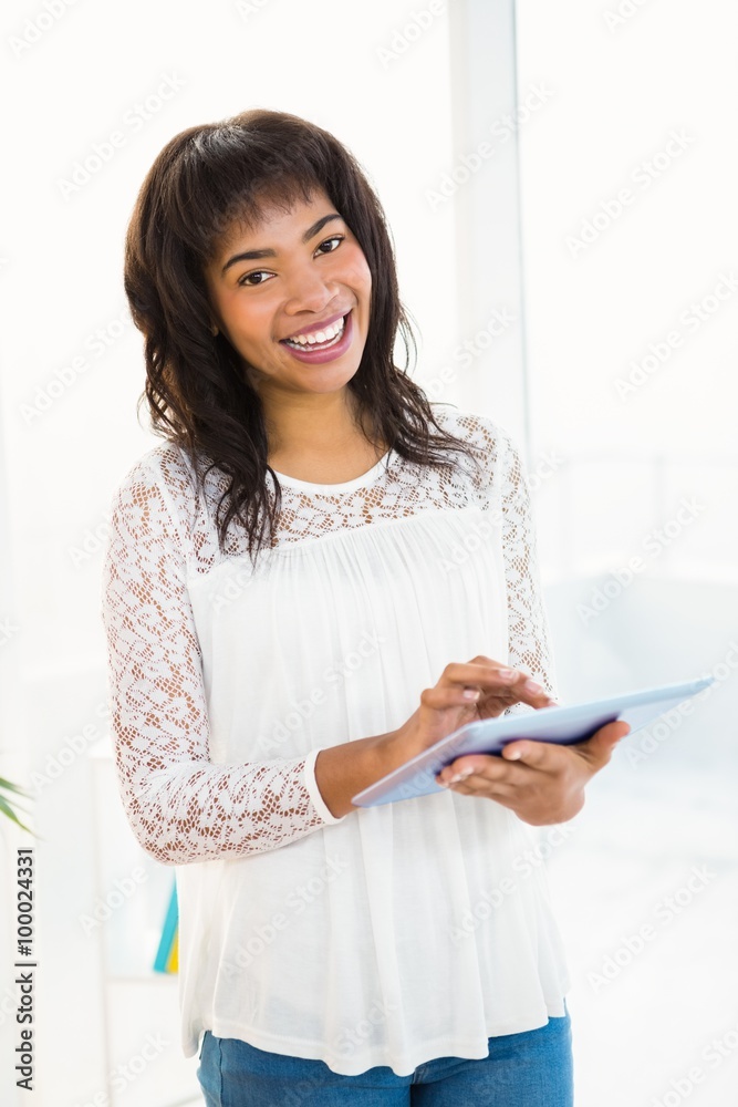 Smiling woman using her tablet in living room Smiling woman using her tablet in living room