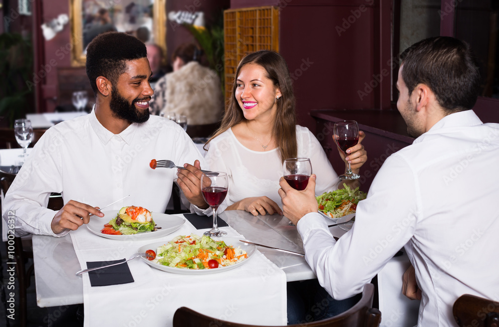 friends eating at restaurant table and chatting