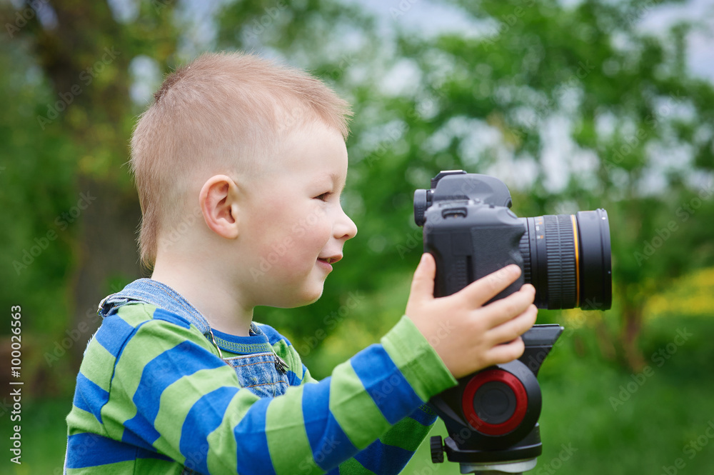 Little boy with an camera shooting outdoor Little boy with an camera shooting outdoor