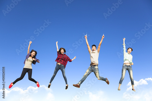 happy young group jumping together