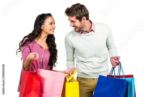 Stylish couple holding shopping bags 