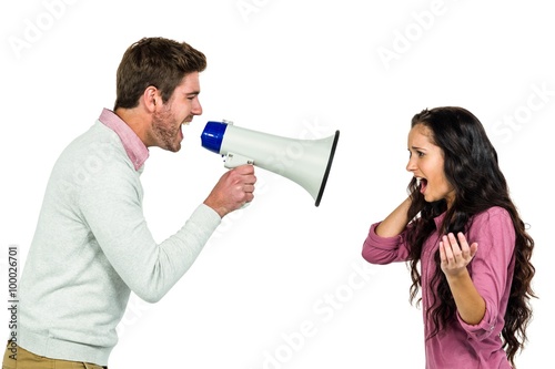 Screaming couple with man holding loudspeaker 