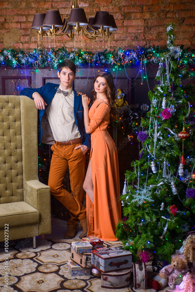 Portrait of a man and woman near the Christmas tree.