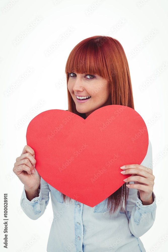 Attractive hipster woman behind a red heart Attractive hipster woman behind a red heart