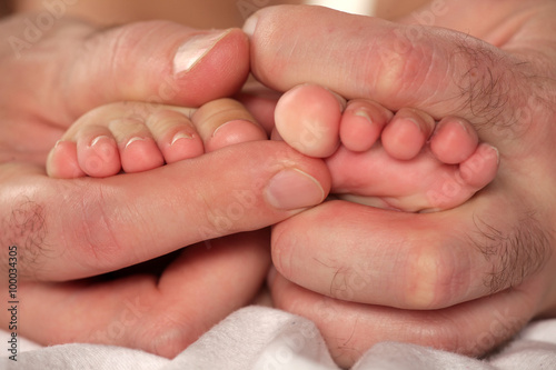 baby feet in father's hands