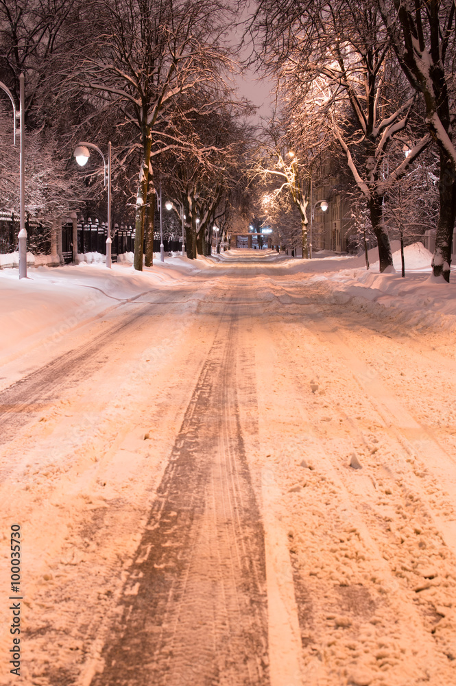 Night snowy road light with lanterns