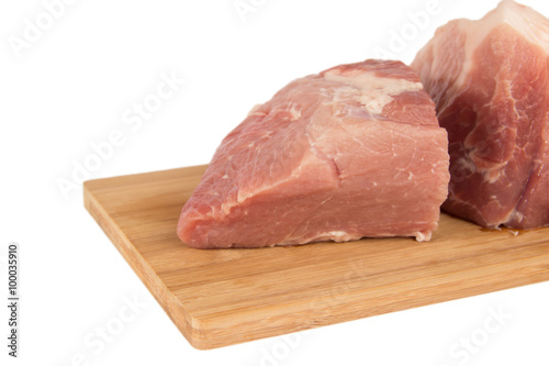 Raw piece of meat on a wooden board on a white background