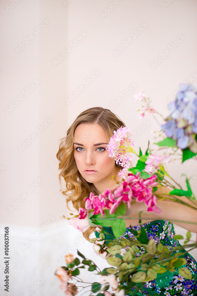 the girl poses near flowers
