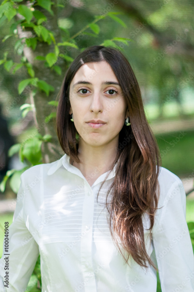 cute girl model walks in the lush garden