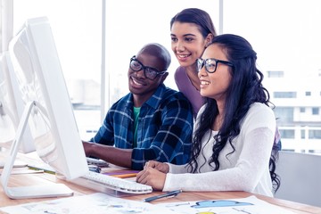 Happy business people working on computer