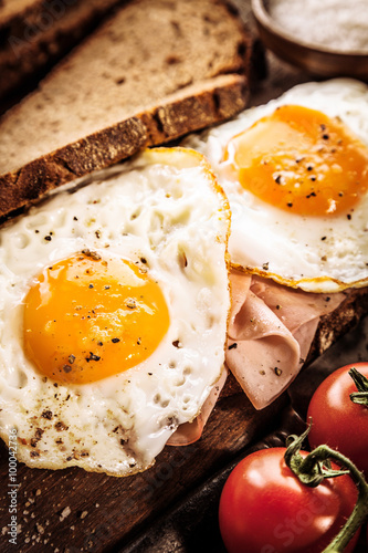 Tasty eggs, ham and tomato breakfast photo