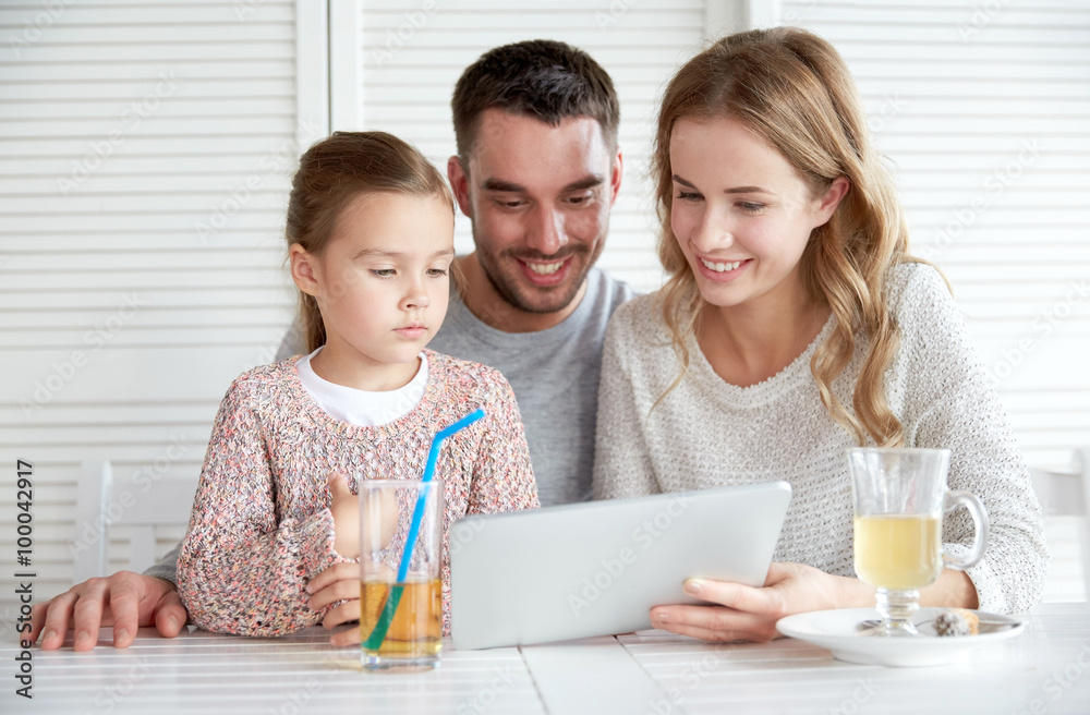 happy family with tablet pc at restaurant happy family with tablet pc at restaurant