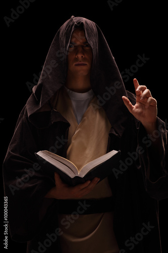 Billede på lærred Mysterious monk holding a book and preaching