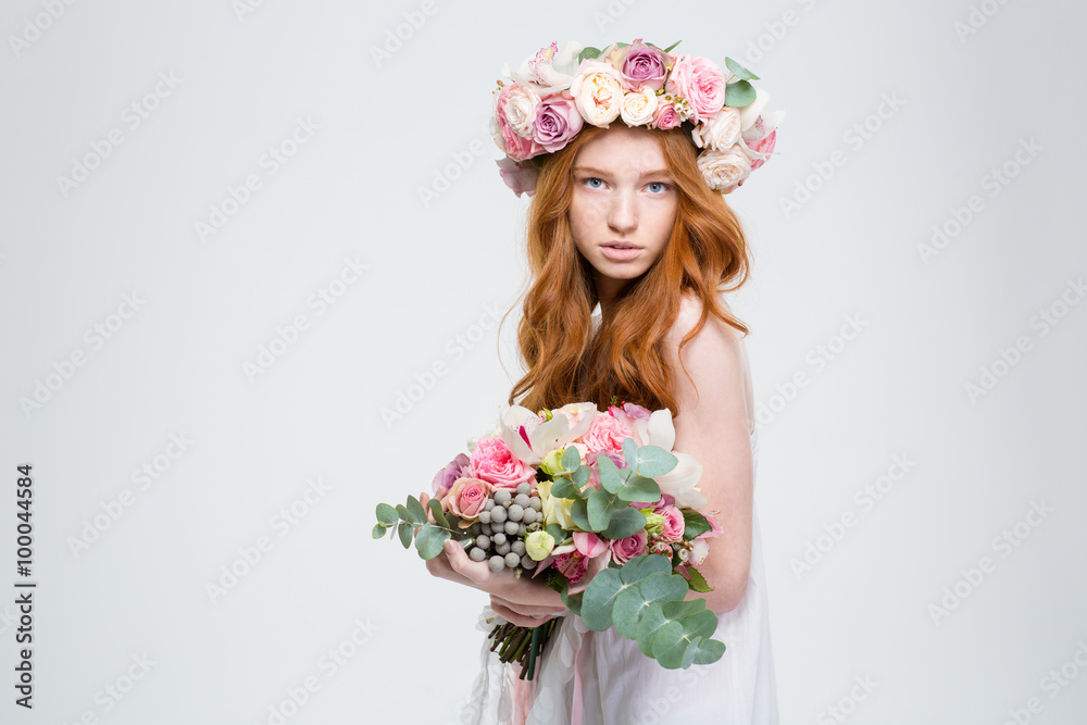 Beautiful female in wreath of roses posing with flower bouquet Beautiful female in wreath of roses posing with flower bouquet
