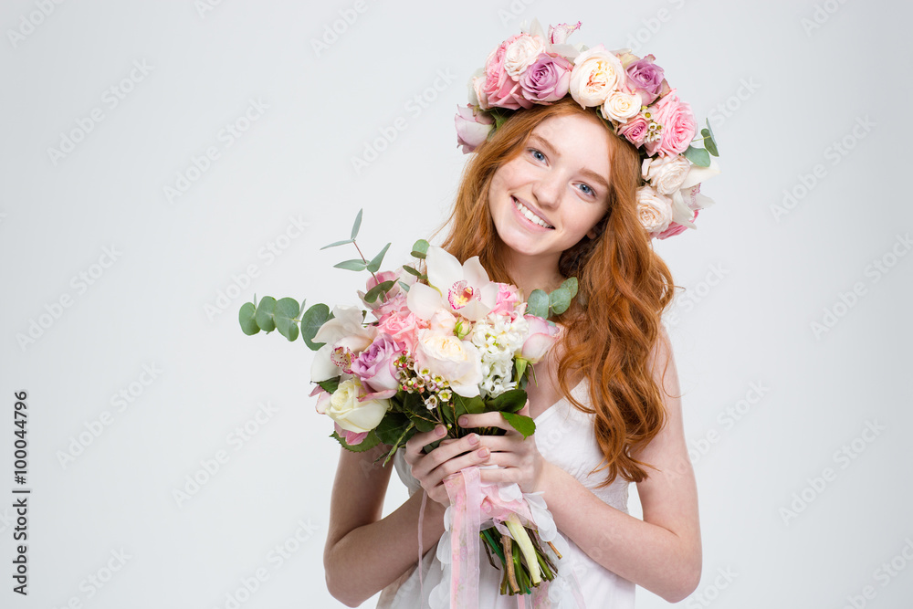 Smiling attractive young woman in wreath holding bouquet of flowers Smiling attractive young woman in wreath holding bouquet of flowers