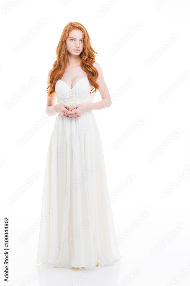 Beautiful young woman with wavy long hair in wedding dress