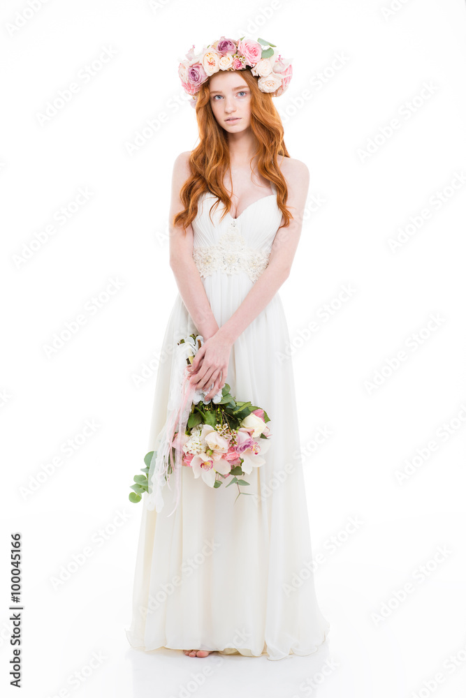Charming redhead woman in dress holding flowers Charming redhead woman in dress holding flowers