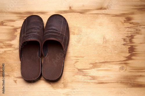 Men's brown boots on a wooden floor